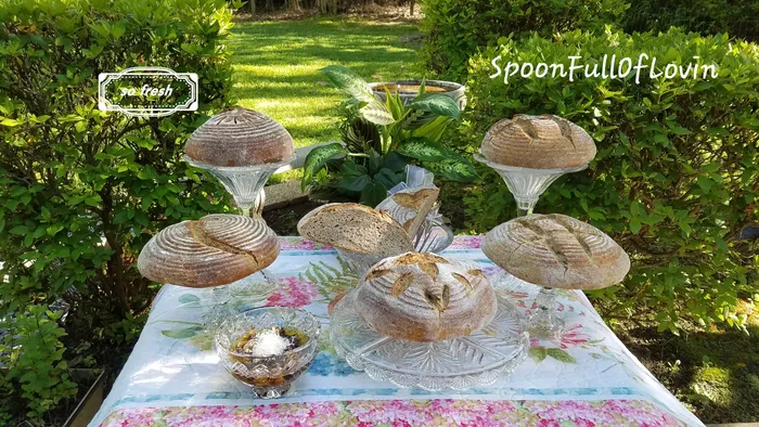 Styled outdoor garden table with artisan baked goods and woven baskets
